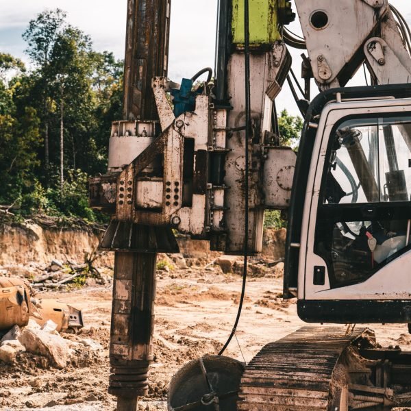 A vertical shot of a construction site near the forest